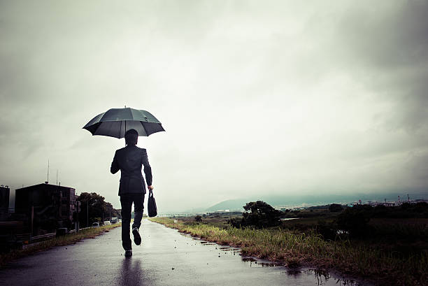 istock businessman are holding an umbrella, dark image 583861740