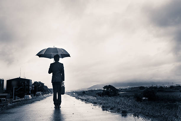 istock businessman are holding an umbrella, dark image 583861758