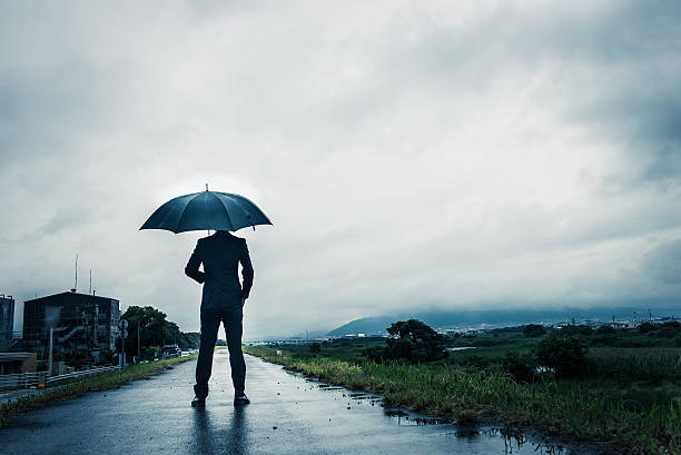 istock businessman are holding an umbrella, dark image 583861820
