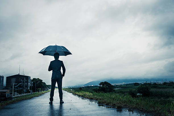 istock businessman are holding an umbrella, dark image 583861826