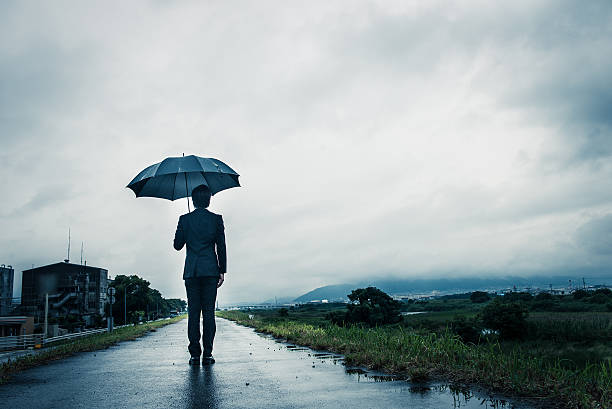 istock businessman are holding an umbrella, dark image 583861842