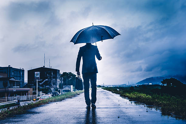 istock businessman are holding an umbrella, dark image 583861972