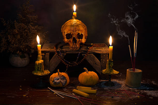 istock Skull with candle light in the dark night 583959068