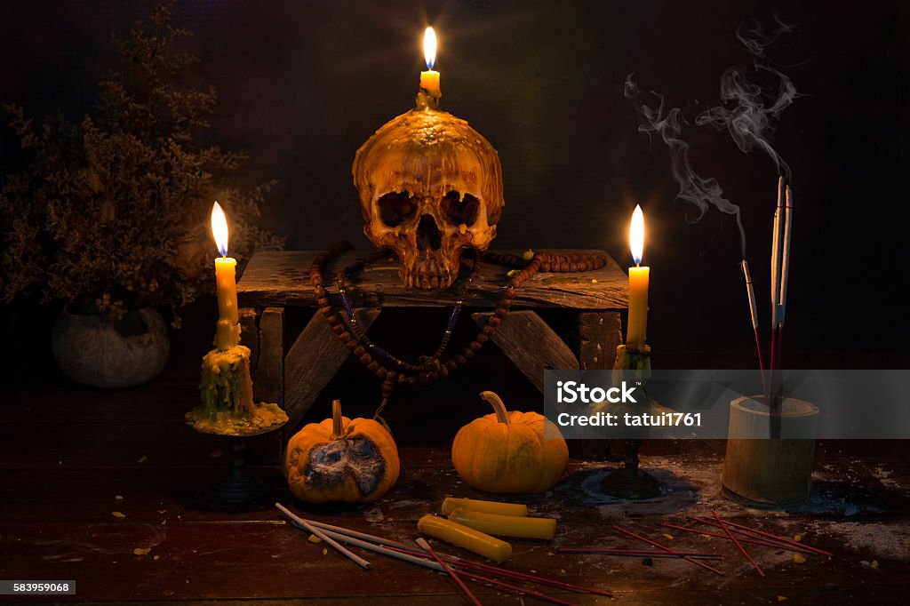 Skull with candle light in the dark night Skull with candle light in the dark night / Still Life image Ash Stock Photo