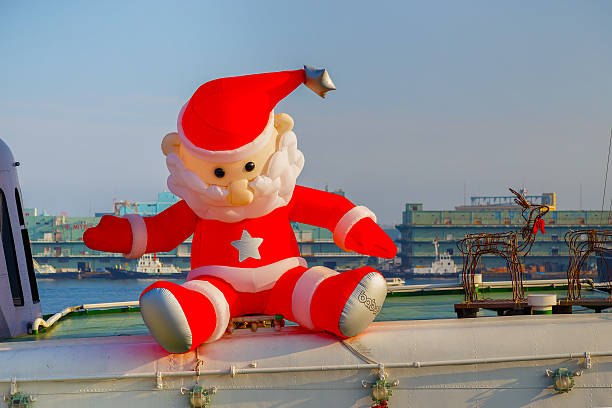 Inflatable santa claus doll Yokohama, Japan - November 24 2015: Inflatable santa claus doll on the top deck of a ship at Yokohama port blow up doll stock pictures, royalty-free photos & images