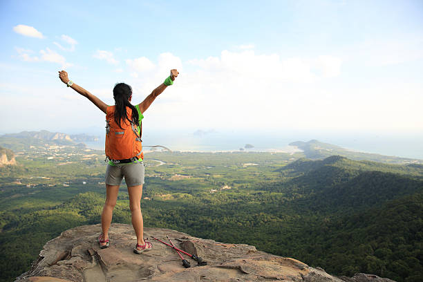 istock young successful woman hiker open arms on mountain peak 583960852