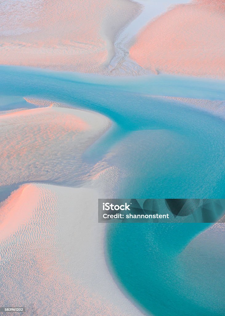 Weaving Water A tidal delta in Australia weaves its way to the sea. Stunning late afternoon colours illuminate the coastal landscape. Aerial image photographed near Broome, Western Australia. Australia Stock Photo