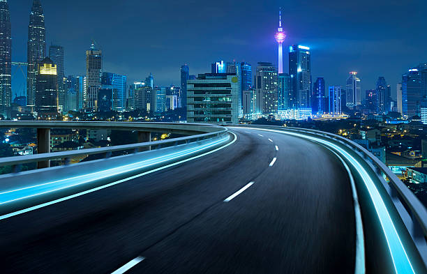 istock Highway overpass motion blur with city background . 583963902