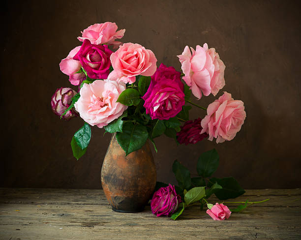 istock Red rose on wooden table 583964578