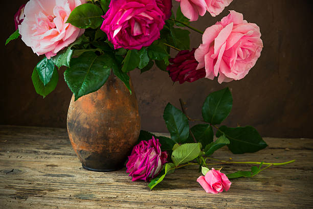 istock Red rose on wooden table 583964664