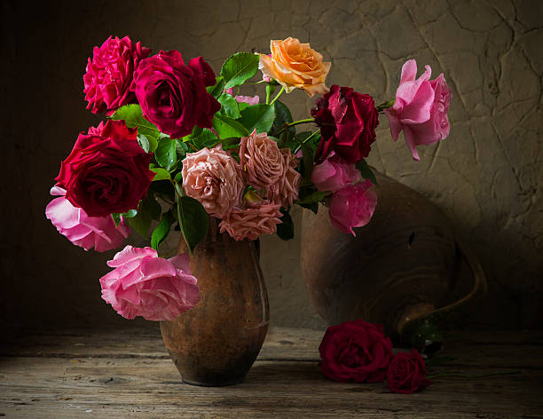 istock Red rose on wooden table 583964844