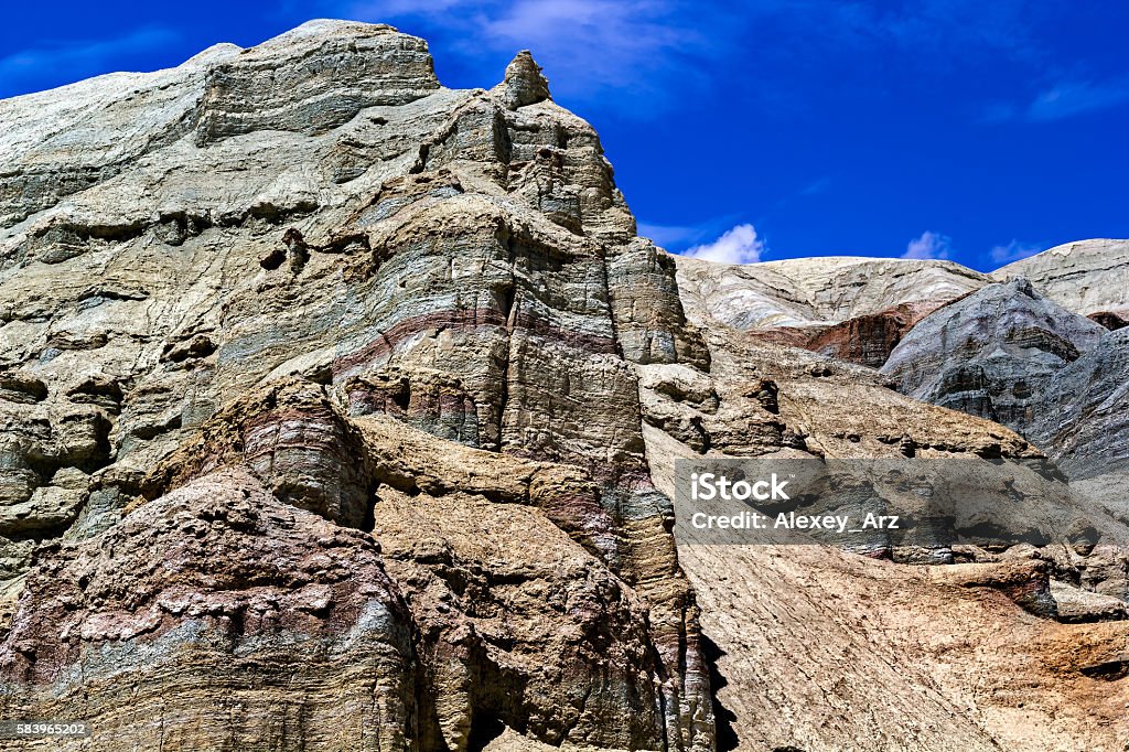 colorful rocks on the background of blue sky with clouds Adventure Stock Photo