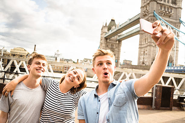 istock friends take a selfie in london - Tower bridge 583965238