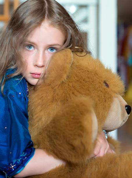 istock Cute little girl with toy bear. 583966730