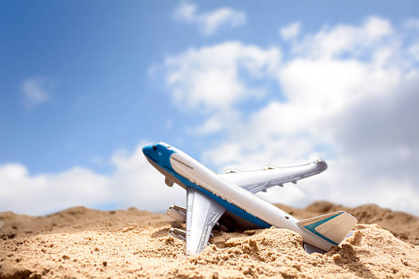 istock toy plane rises from the sand against the blue sky 583967342
