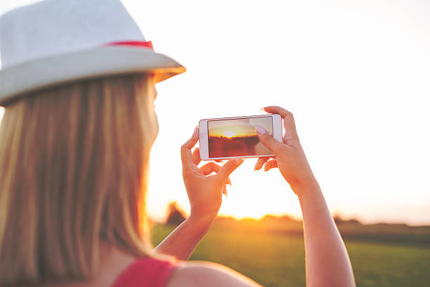 istock Woman taking photos with phone 583967930
