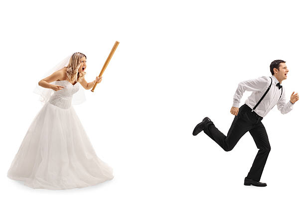 Bride chasing the groom with a bat Angry bride chasing the groom with a baseball bat isolated on white background scary bride stock pictures, royalty-free photos & images