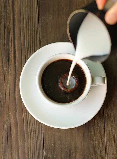 istock Hot coffee black coffee drop the milk 583970172