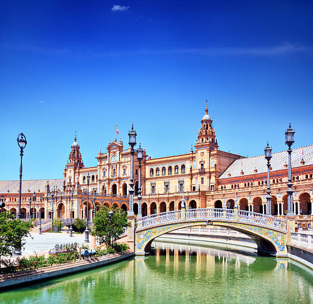 Seville, Spain - December 31, 2023:  Beautiful doors with superior workmanship of bricks and tiles of Plaza de Espana.  HDR encoded.