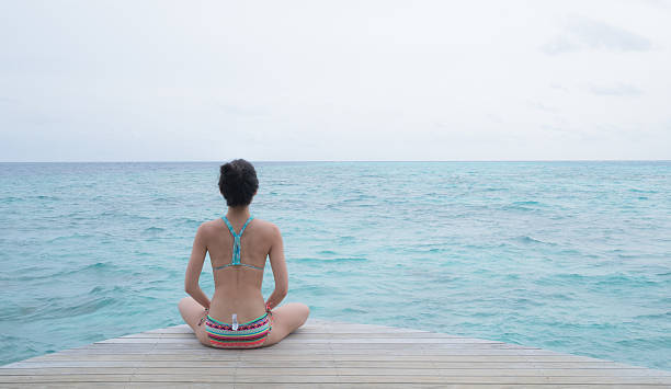 istock Yoga post in front of clear blue ocean 583971020