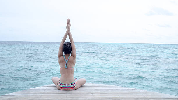 istock Yoga post in front of clear blue ocean 583971070