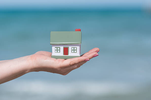 istock small house at the ocean - concept for dream house 583971776