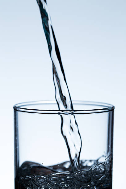 istock pouring water from a bottle into glass 583972580