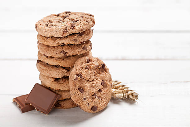 istock Cookies tower and chocolate on old white table 583972866