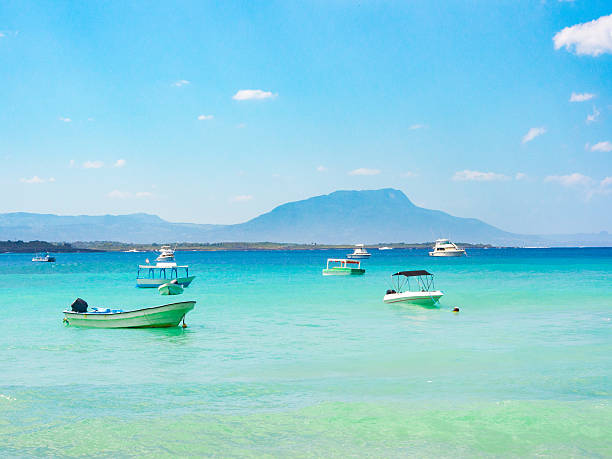 Sosua Beach Boats by the sea in Sosua, Dominican Republic puerto plata stock pictures, royalty-free photos & images