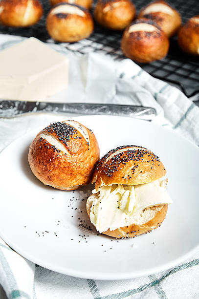 istock Pretzel buns with poppy seeds and butter 583975194