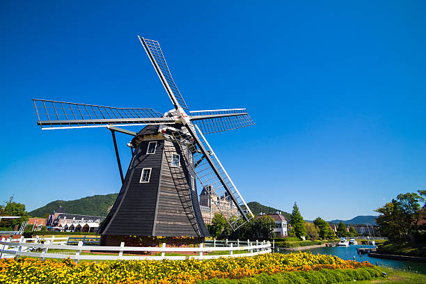 Windmill at Huis Ten Bosch, Japan Windmill at Huis Ten Bosch stand in a bright and clear sky, Japan nagasaki prefecture photos stock pictures, royalty-free photos & images