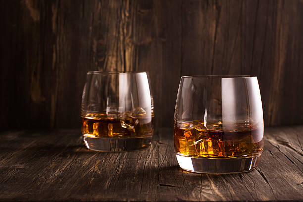 istock Cognac in glasses over wooden table 583975920