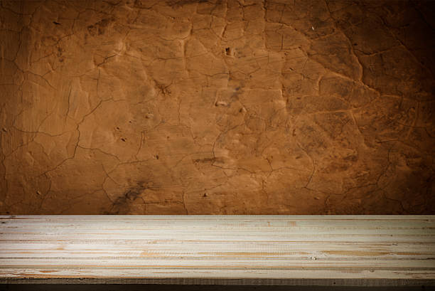 istock Wooden deck table on green grunge background 583976228