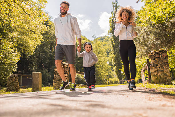 istock Happy family having fun while running in the park. 583976502
