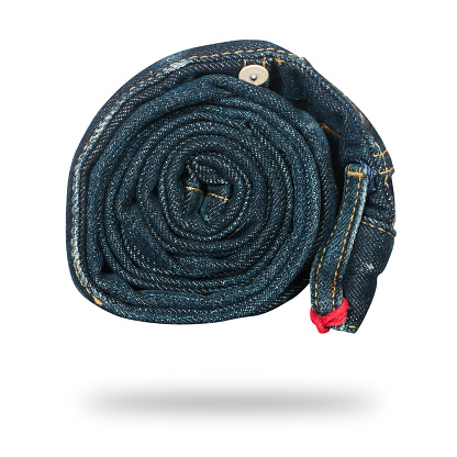jeans twisted in roll isolated on white