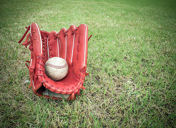istock Nostalgic baseball in glove on a baseball field 583977292