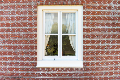 White color vintage style window with brick wall