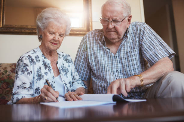 istock Senior couple doing retirement paperwork 583979736