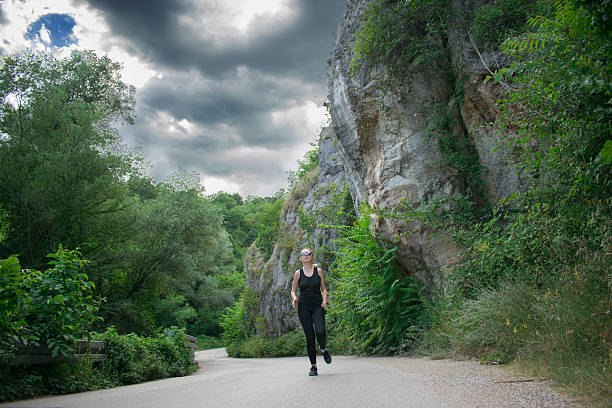 istock The blond girl jogging under the clouds 583981440