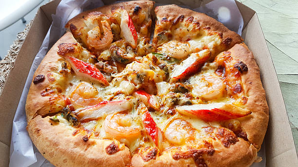istock Pizza with seafood  delicious in delivery box 583984538
