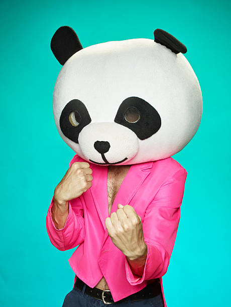 istock The guy in pink tailcoat with panda head. 583985826