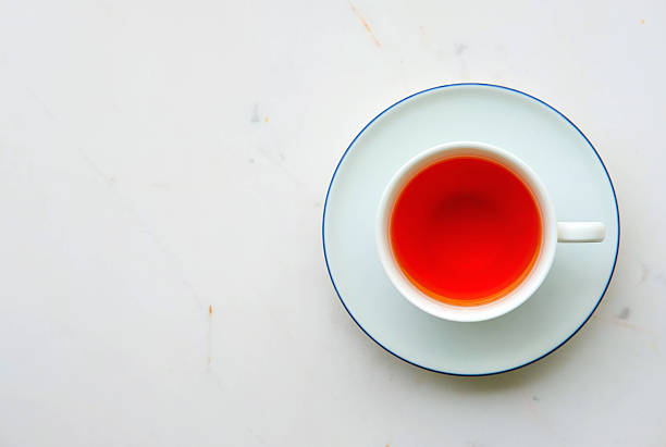 istock Cup of tea on white marble desk 583986572