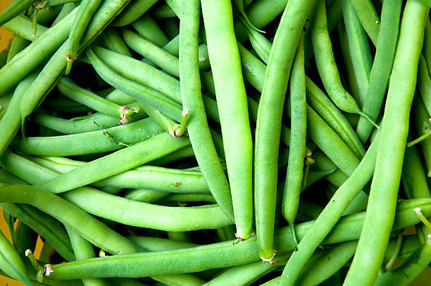 istock Fresh green beans on wooden table 583986664