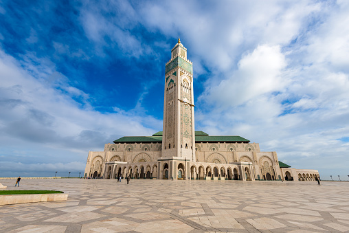 The magnificent Hassan II Mosque is located in Casablanca, Morocco. This architectural masterpiece, renowned for its towering minaret and expansive courtyards, is a symbol of Islamic art and one of the largest mosques in the world, reflecting Morocco's religious and cultural grandeur.