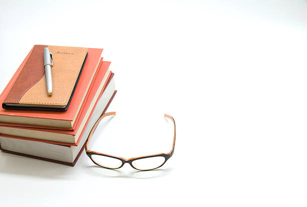 istock Notebook,books and glasses on white background 583987374