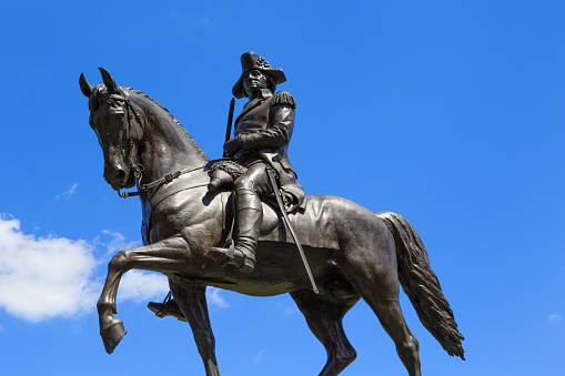 A photograph of the Equestrian Statue of George Washington, by Thomas Ball in 1869, in the Boston Public Garden. The Public Garden is a large park located in the heart of Boston, Massachusetts, adjacent to Boston Common.