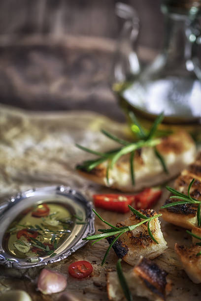 istock Ciabatta bread with olive oil and herbs 583989008