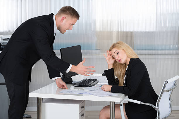 istock Boss Shouting At Employee Sitting At Desk 583989348