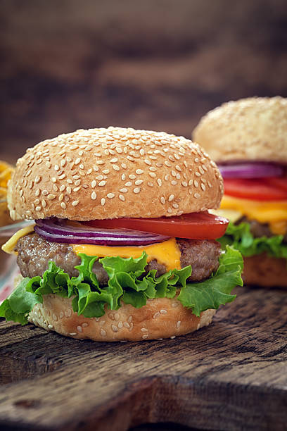 istock Cheeseburgers on the wooden background 583990052