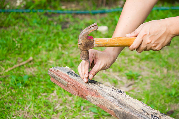 istock Close up of man hitting nail by hammer 583991106